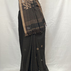 Black saree with gold border on a mannequin against a white background
