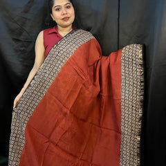 Model wearing Brown Red Kota Doria handloom saree with golden checks outdoors