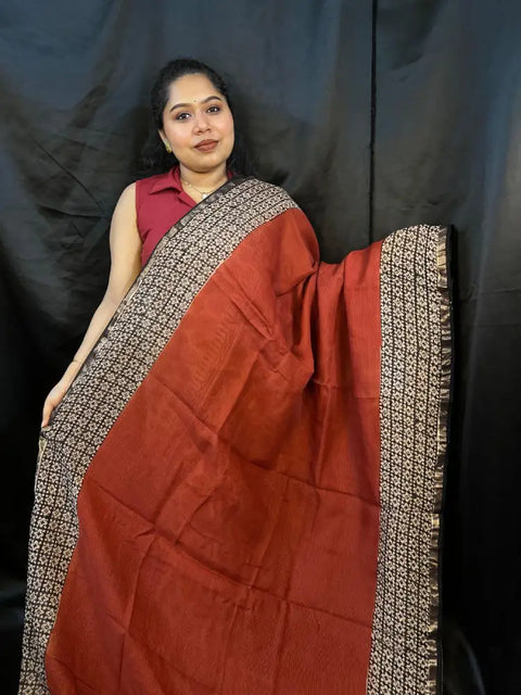 Model wearing Brown Red Kota Doria handloom saree with golden checks outdoors