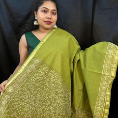 Lightweight green cotton Kota saree displayed on hanger