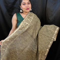 Woman holding a traditional saree with a black background