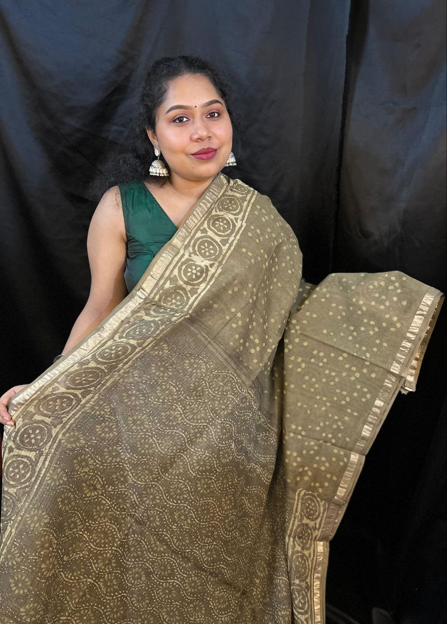Woman holding a traditional saree with a black background