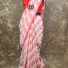 Back view of red white handloom cotton saree styled in traditional Bengali drape