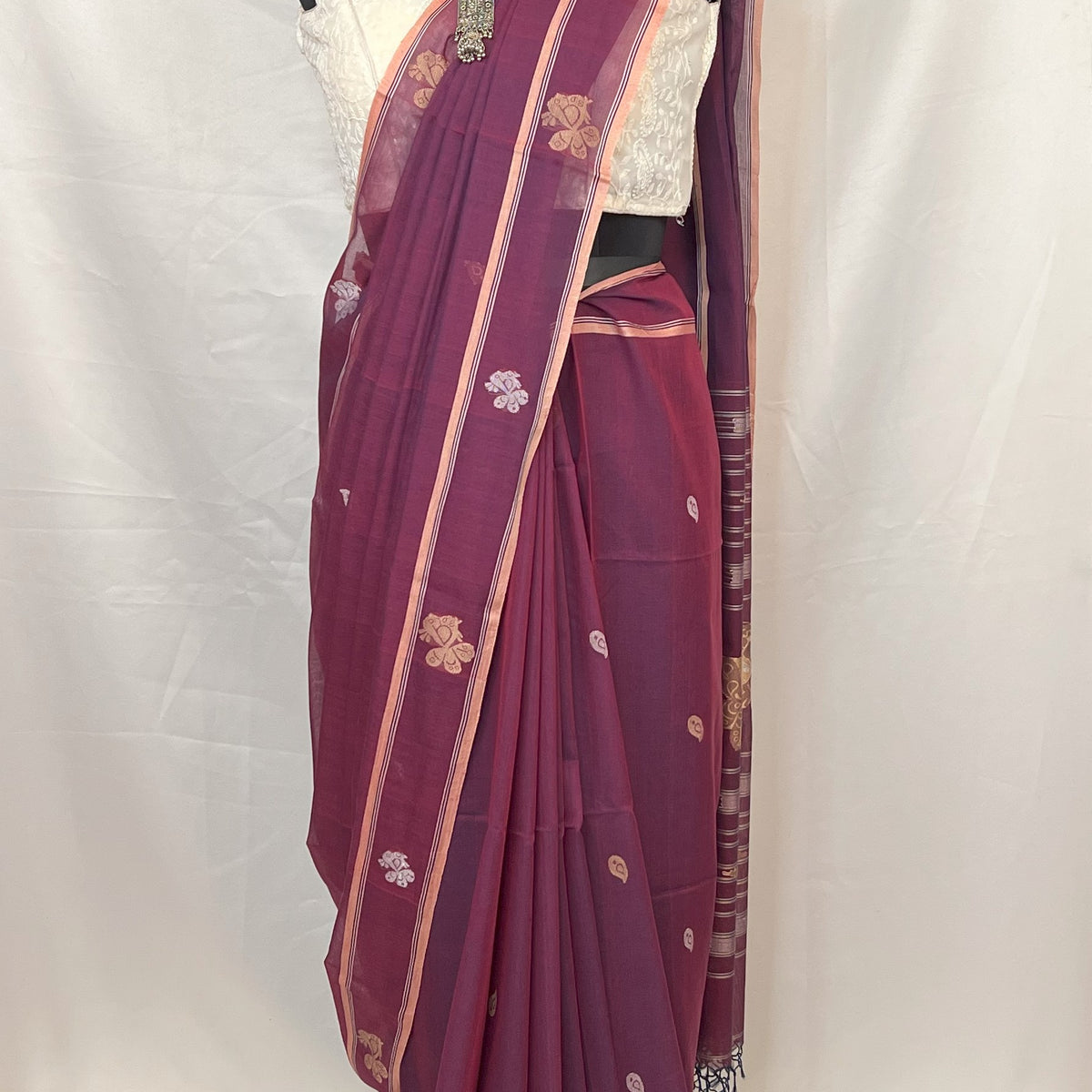 Baluchari handloom saree in peacock purple cotton featuring woven motifs inspired by Indian heritage.