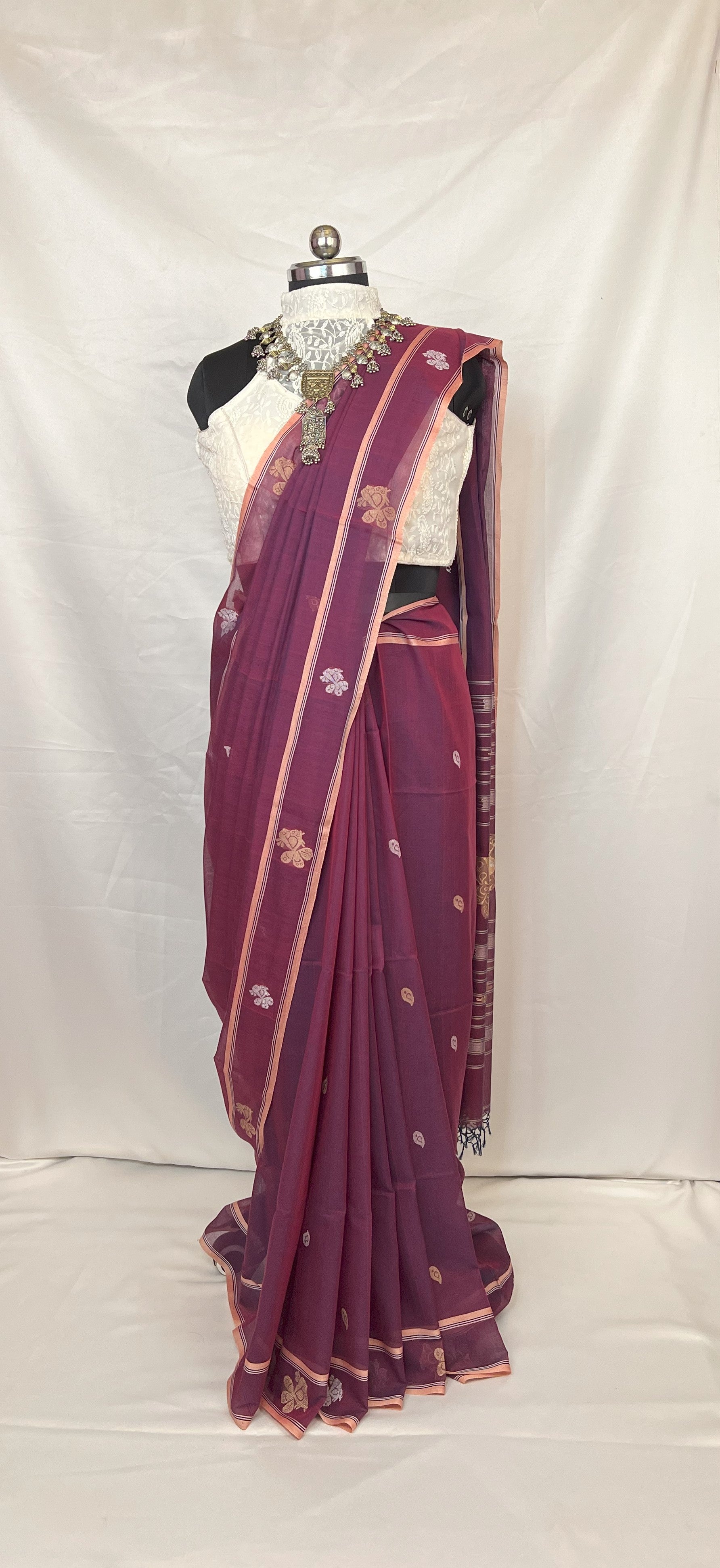 Baluchari handloom saree in peacock purple cotton featuring woven motifs inspired by Indian heritage.