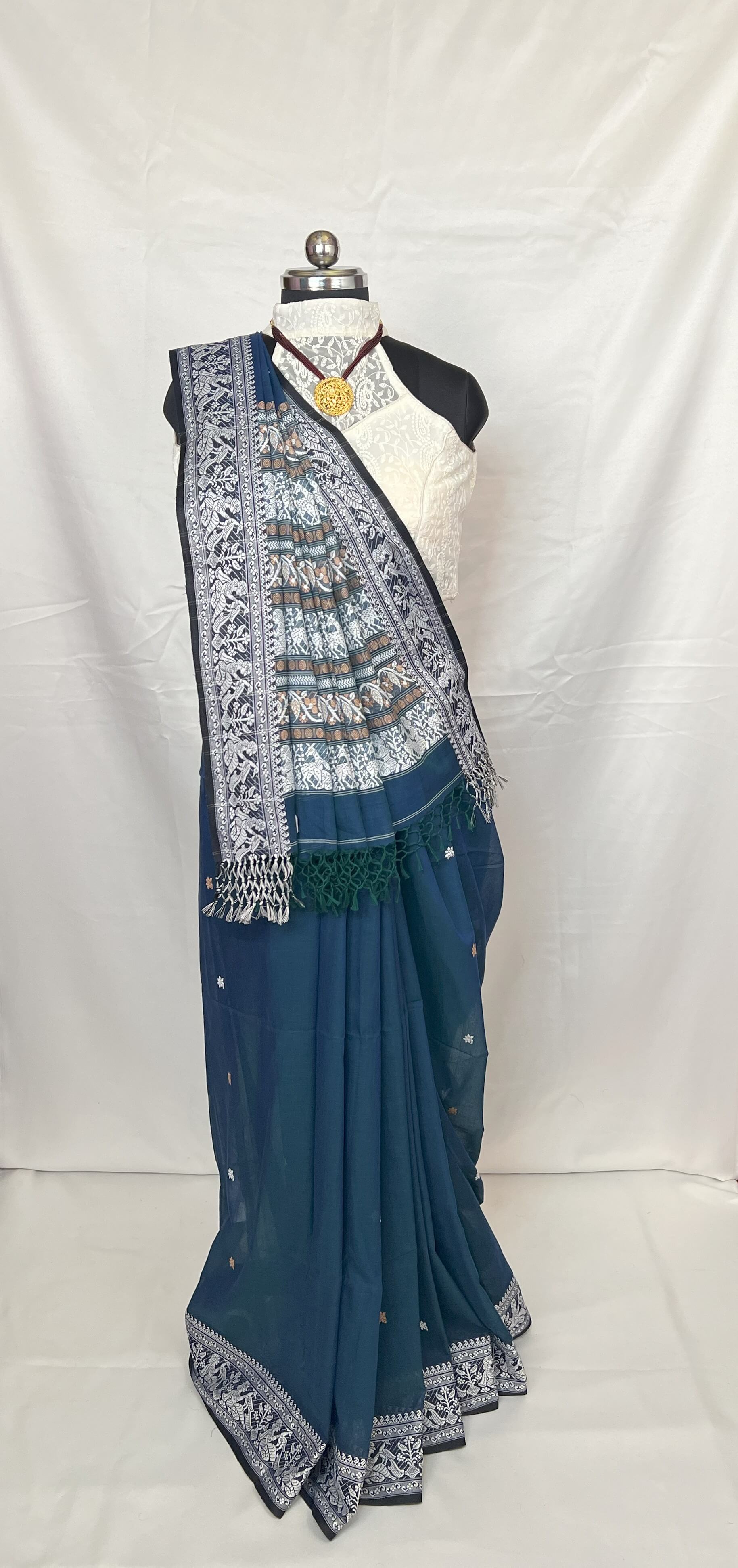 Traditional Baluchari saree pallu design in white weaving on peacock blue cotton fabric.