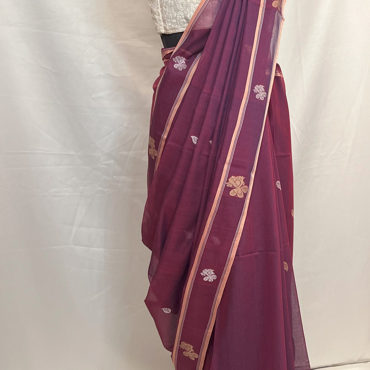 Traditional Bengali Baluchari saree in peacock purple cotton, showcasing heritage weaving art.
