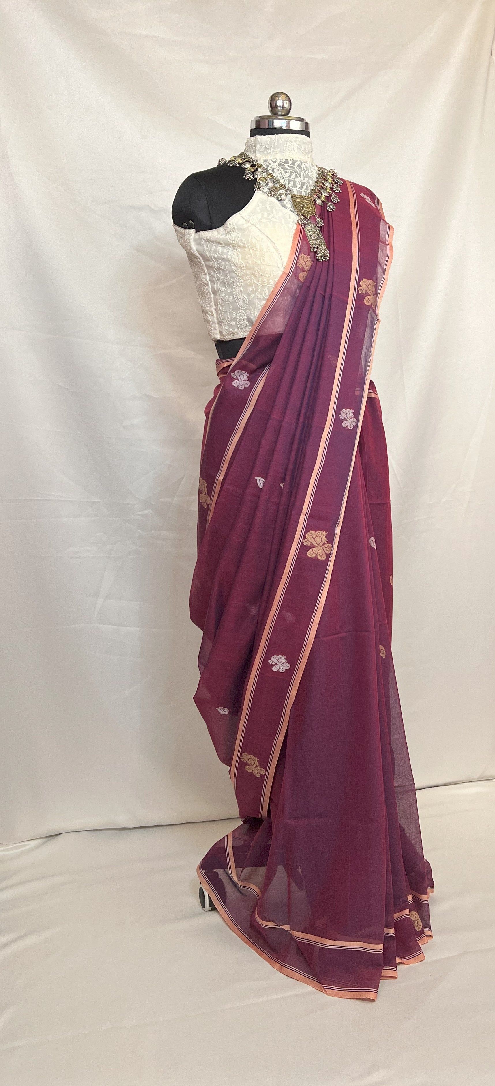 Traditional Bengali Baluchari saree in peacock purple cotton, showcasing heritage weaving art.
