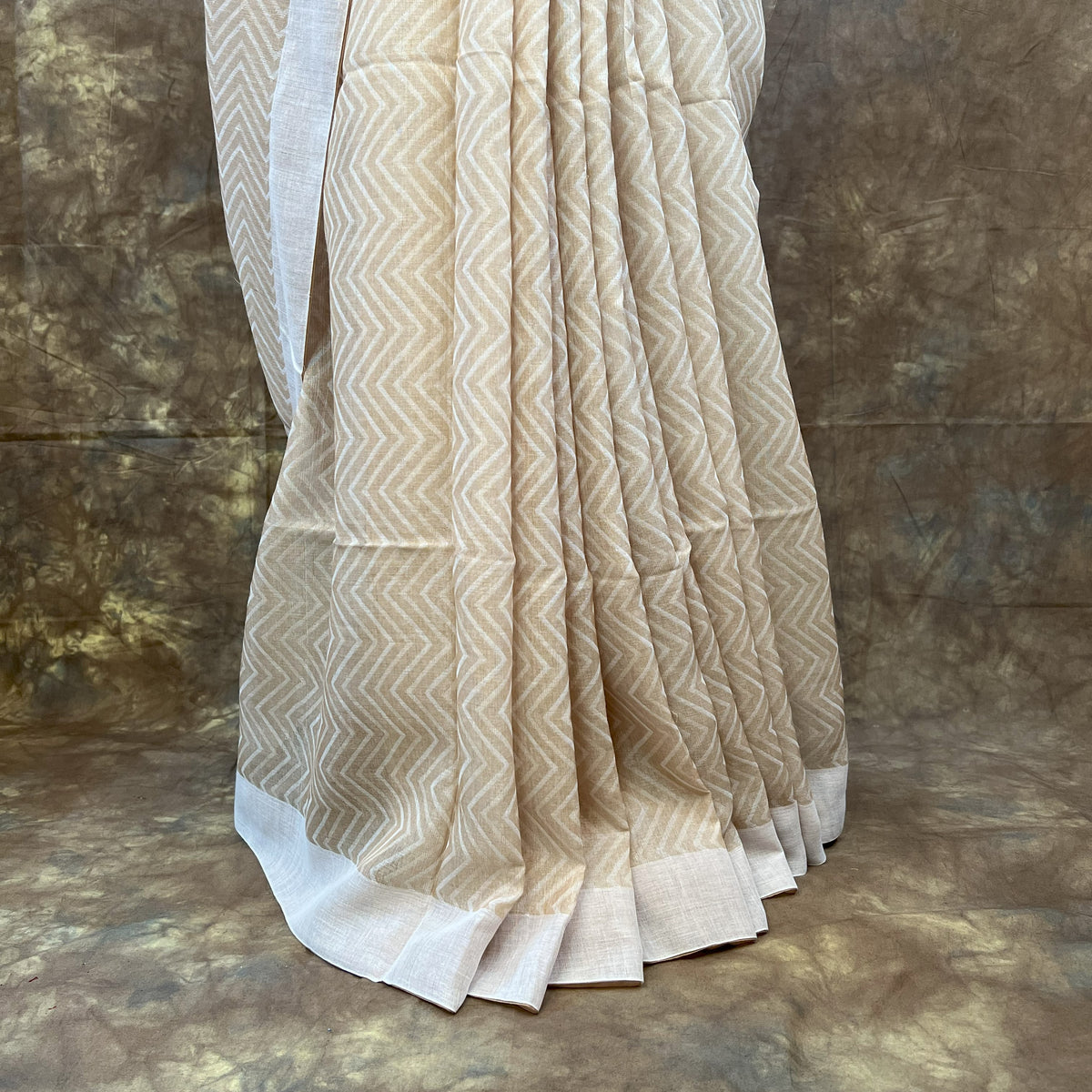 Traditional Bengali tussar saree in white, styled for Durga Puja rituals.