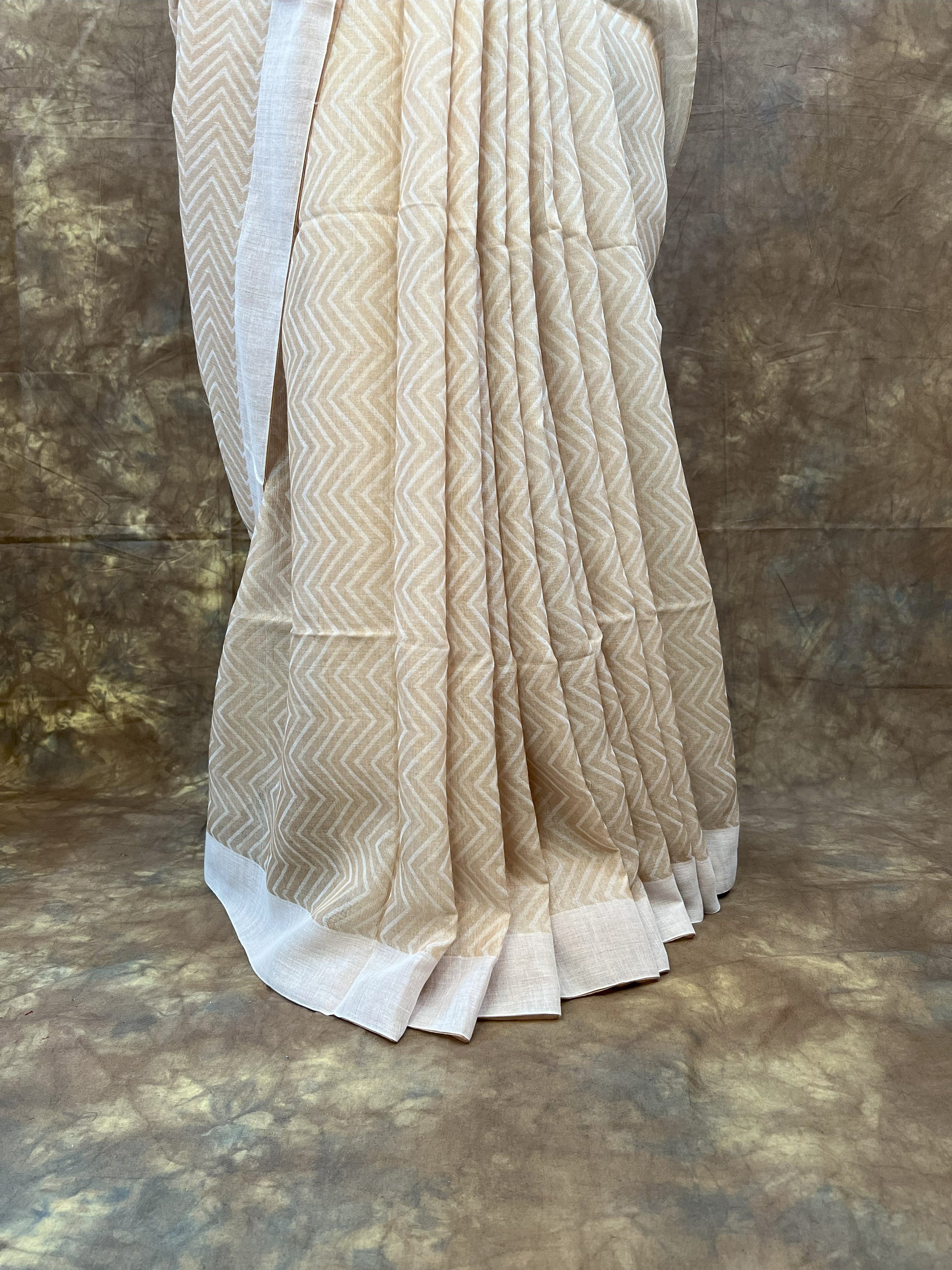 Traditional Bengali tussar saree in white, styled for Durga Puja rituals.