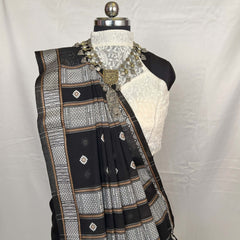 Black and white embroidered saree on a mannequin against a white background