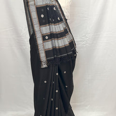 Black saree with silver patterns on a mannequin against a white background