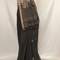 Black saree with gold border on a mannequin against a white background