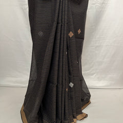 Black and golden striped saree with gold border on a white background