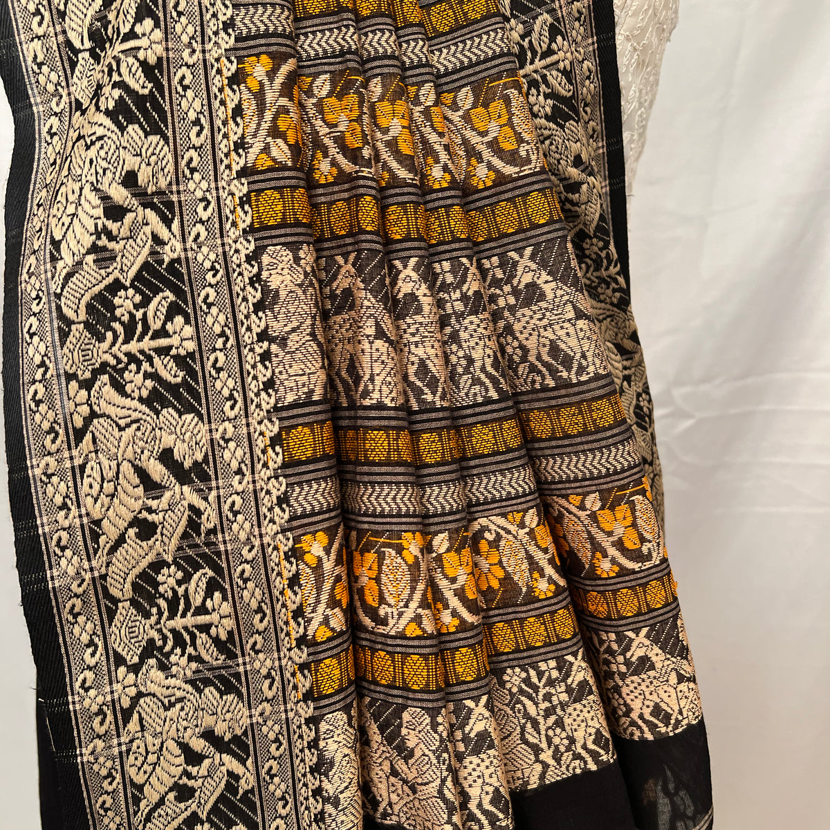 Cotton Baluchari Saree – Draping style showing black handloom fabric.
