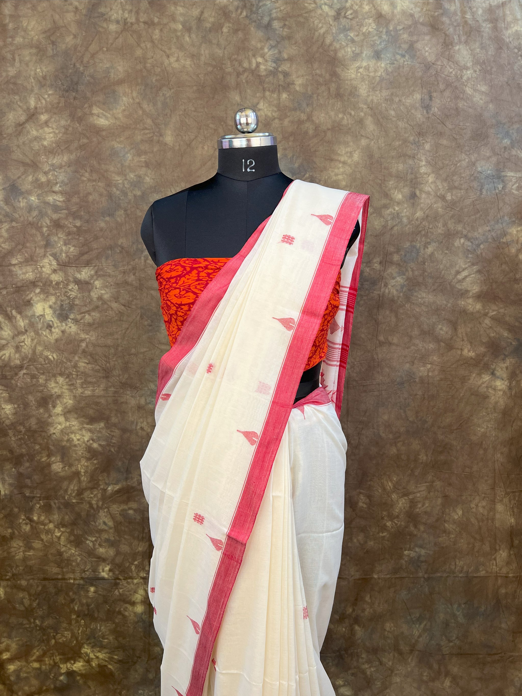 Red and white saree with matching blouse piece for Durga Puja celebrations.