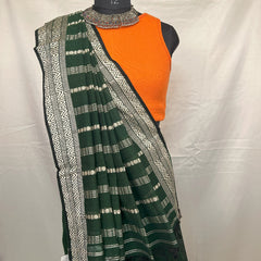 Bengali woman in green handloom saree during Durga Puja.
