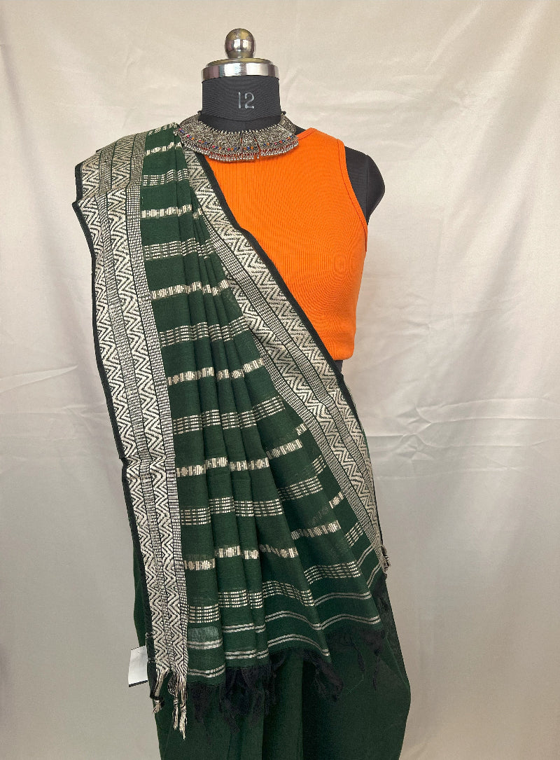 Bengali woman in green handloom saree during Durga Puja.