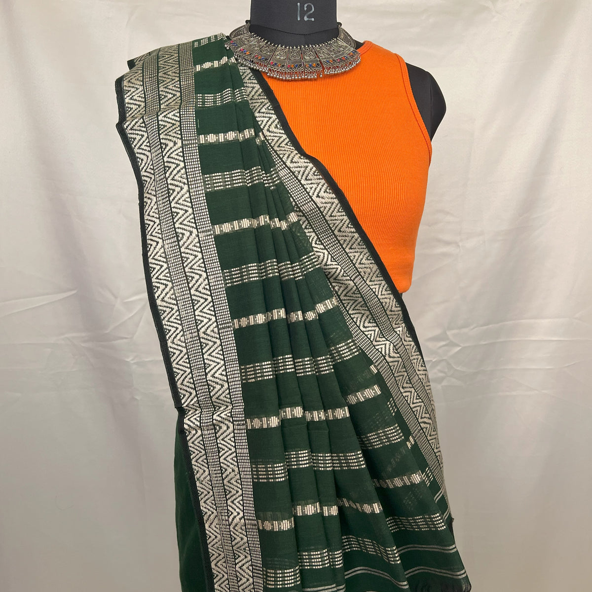 Eco-friendly green cotton handloom saree made from natural fibers.