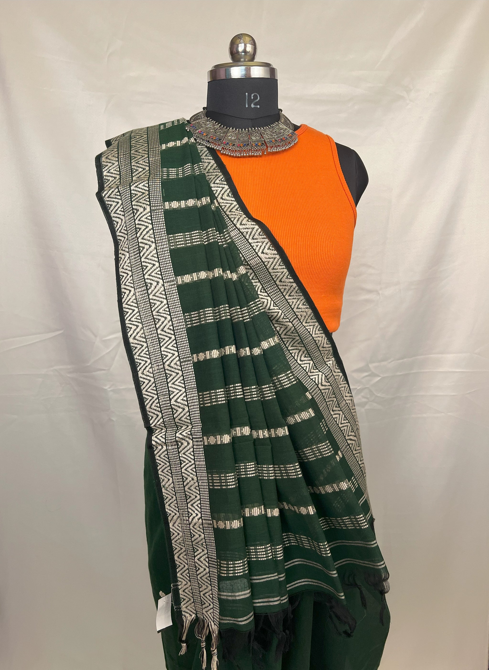 Eco-friendly green cotton handloom saree made from natural fibers.