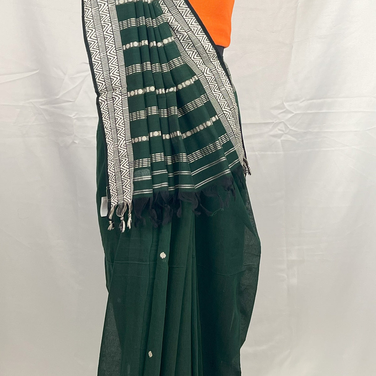 Close-up of woven motifs on green handloom cotton saree.