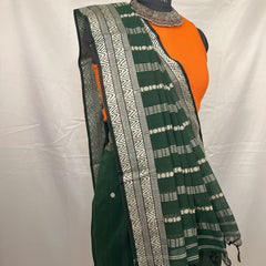 Green handloom saree styled with jewellery for wedding guest look.