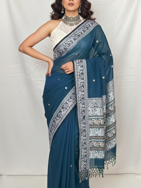 Close-up of Baluchari saree peacock blue cotton fabric with traditional white woven border.