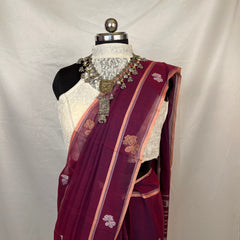 Handloom Baluchari saree in peacock purple highlighting detailed pallu design with heritage craftsmanship.