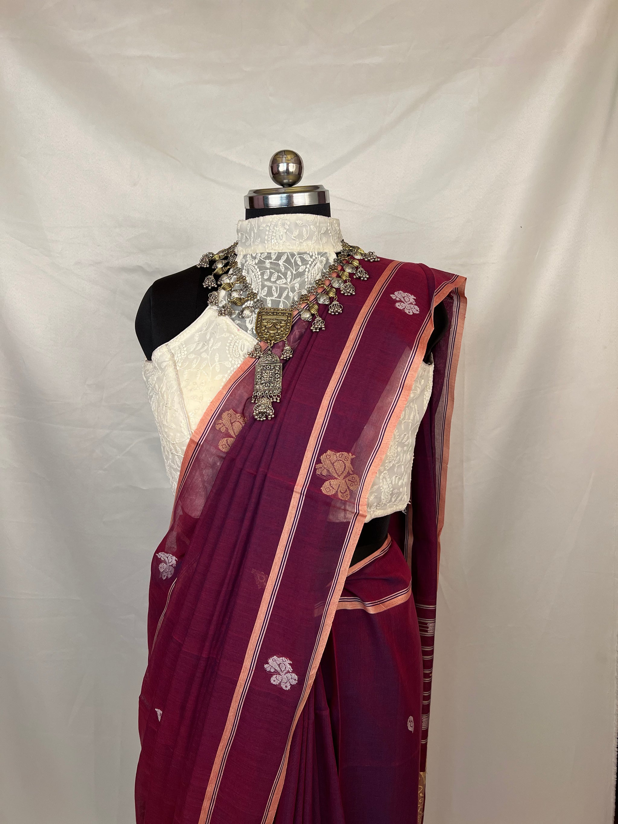 Handloom Baluchari saree in peacock purple highlighting detailed pallu design with heritage craftsmanship.