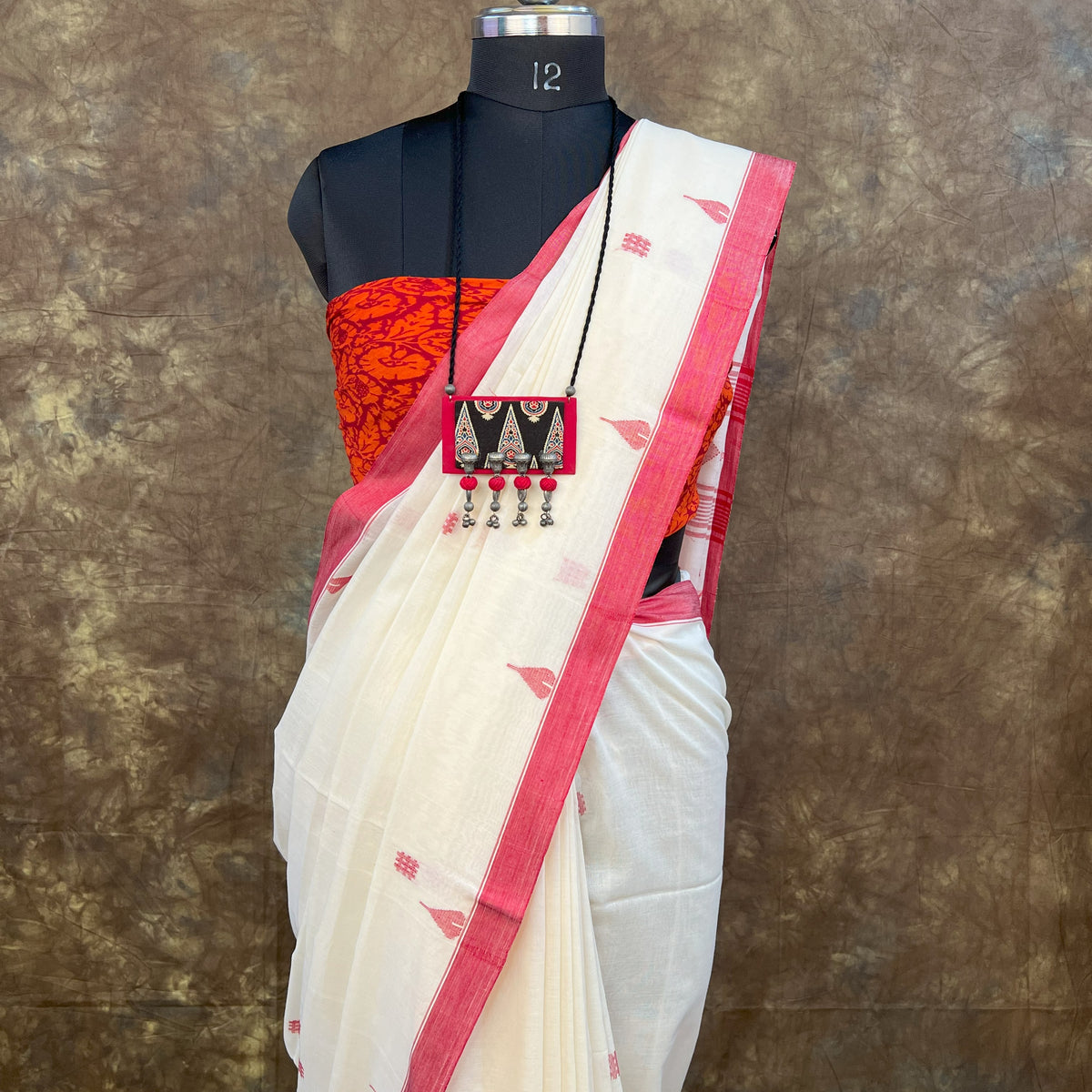 Pure handloom cotton saree in festive red and white colors.