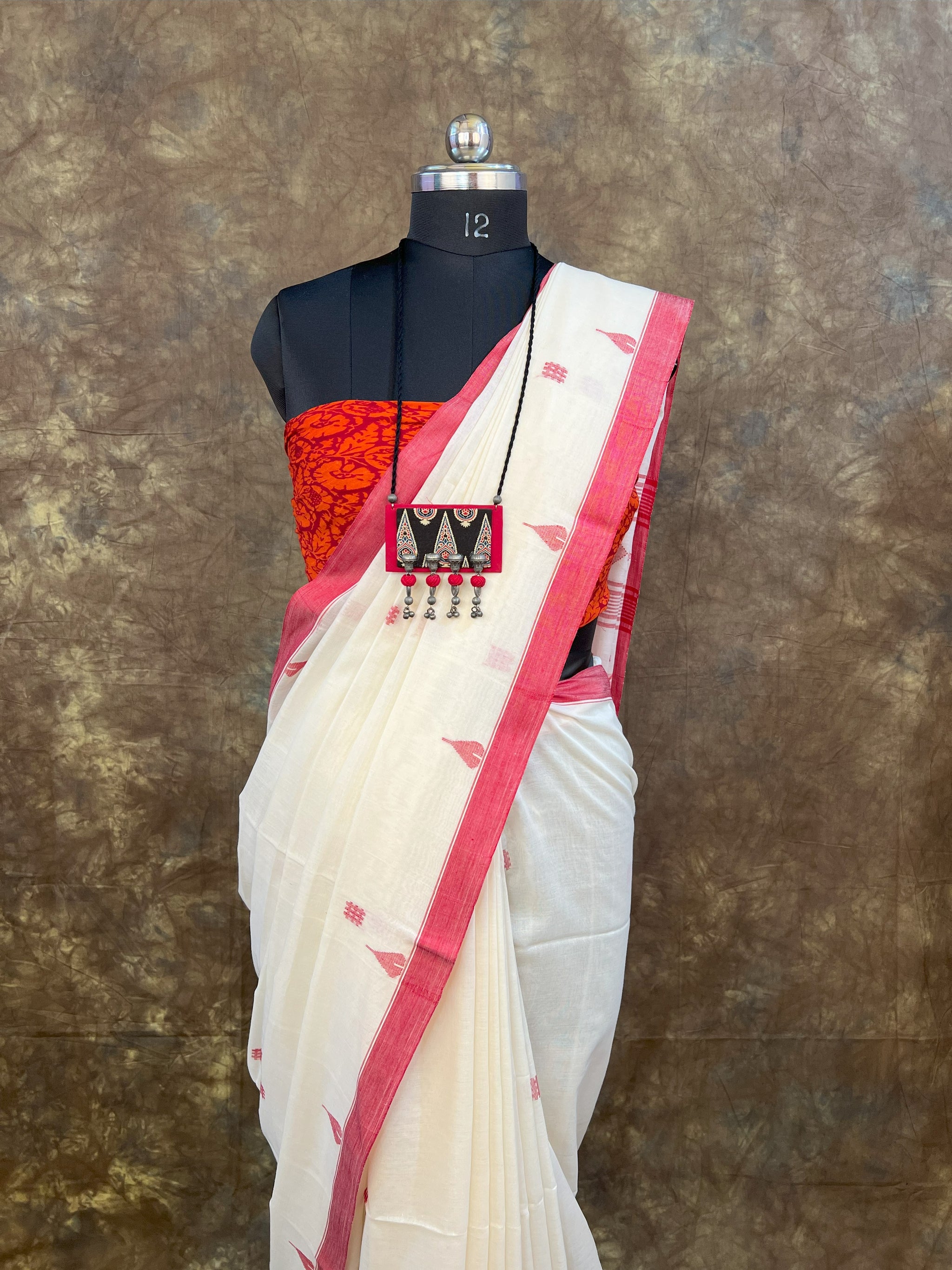 Pure handloom cotton saree in festive red and white colors.