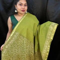 Detailed shot of Kota saree weaving pattern on green fabric