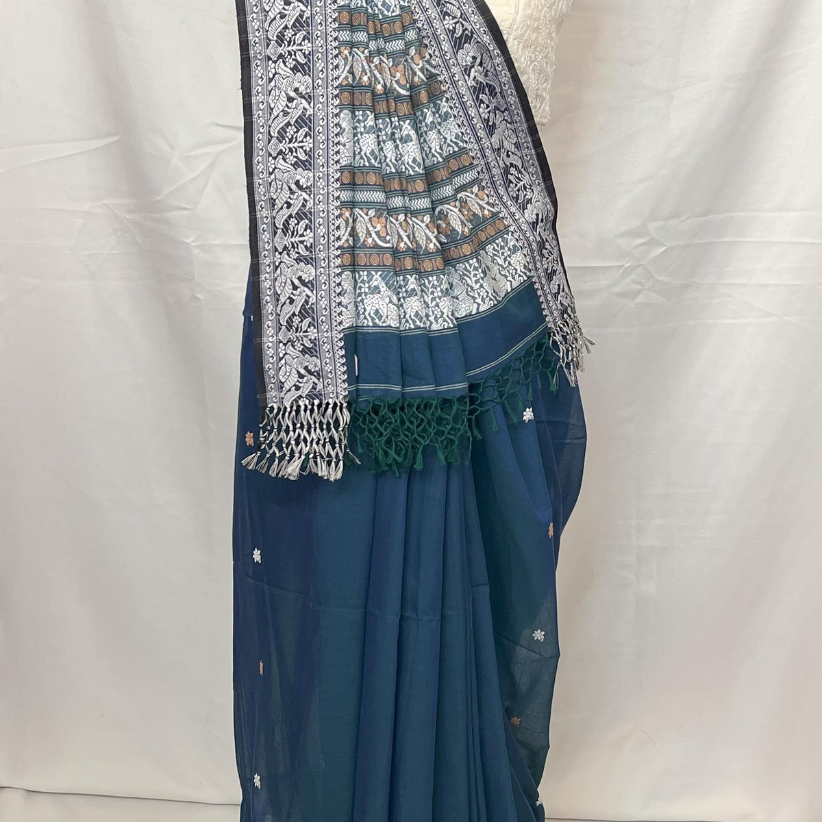 Traditional Bengal Baluchari cotton saree in peacock blue shade with classic woven patterns.
