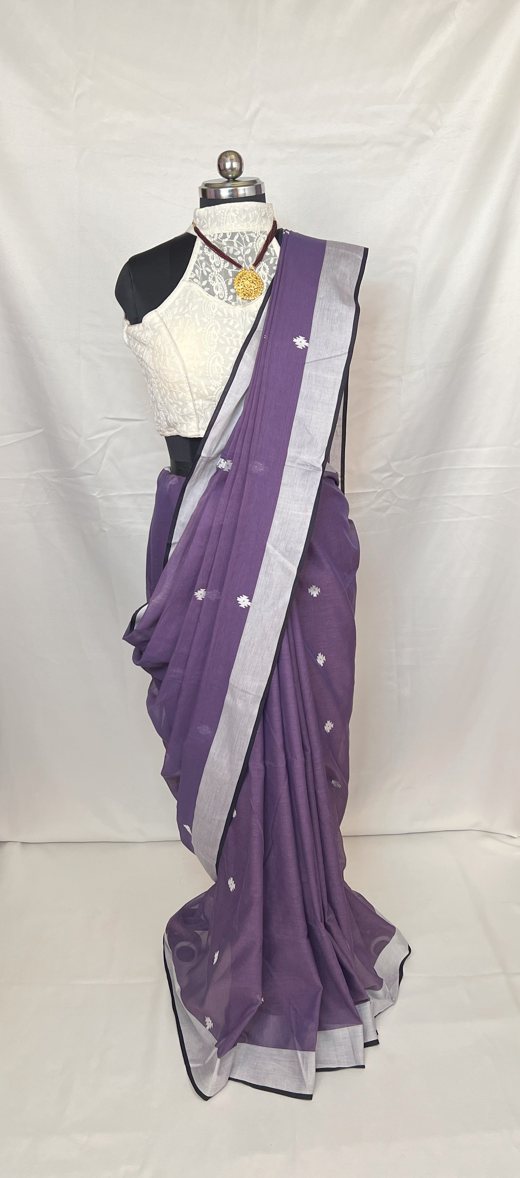 Draped mannequin showcasing Purple Cotton Baluchari Saree with intricate motifs.