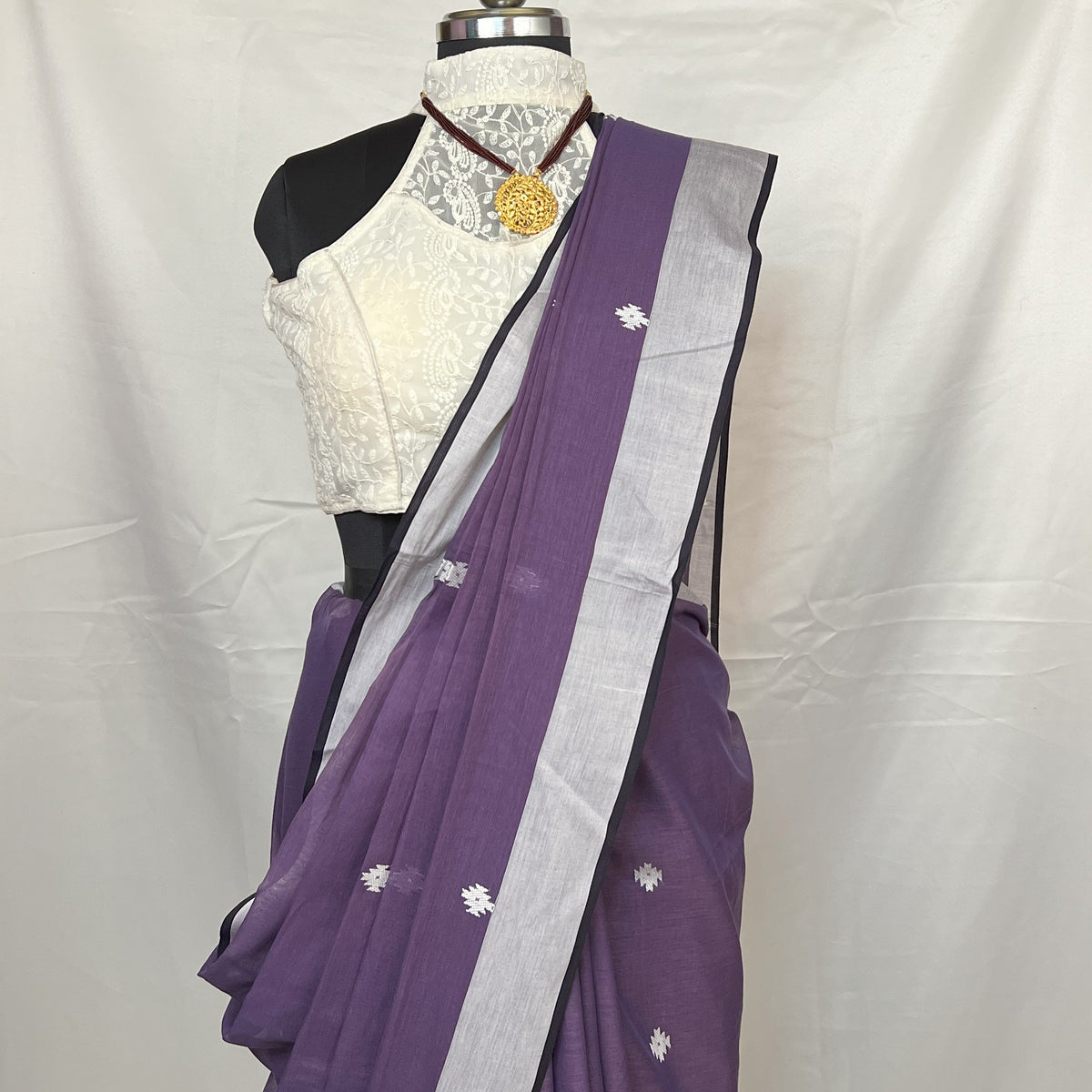 Pleated section of Purple Cotton Baluchari Saree highlighting fine handloom weaving.