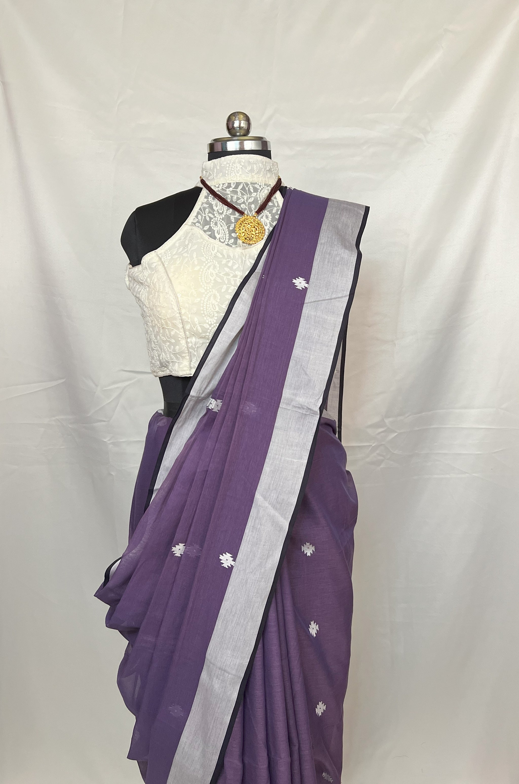 Pleated section of Purple Cotton Baluchari Saree highlighting fine handloom weaving.