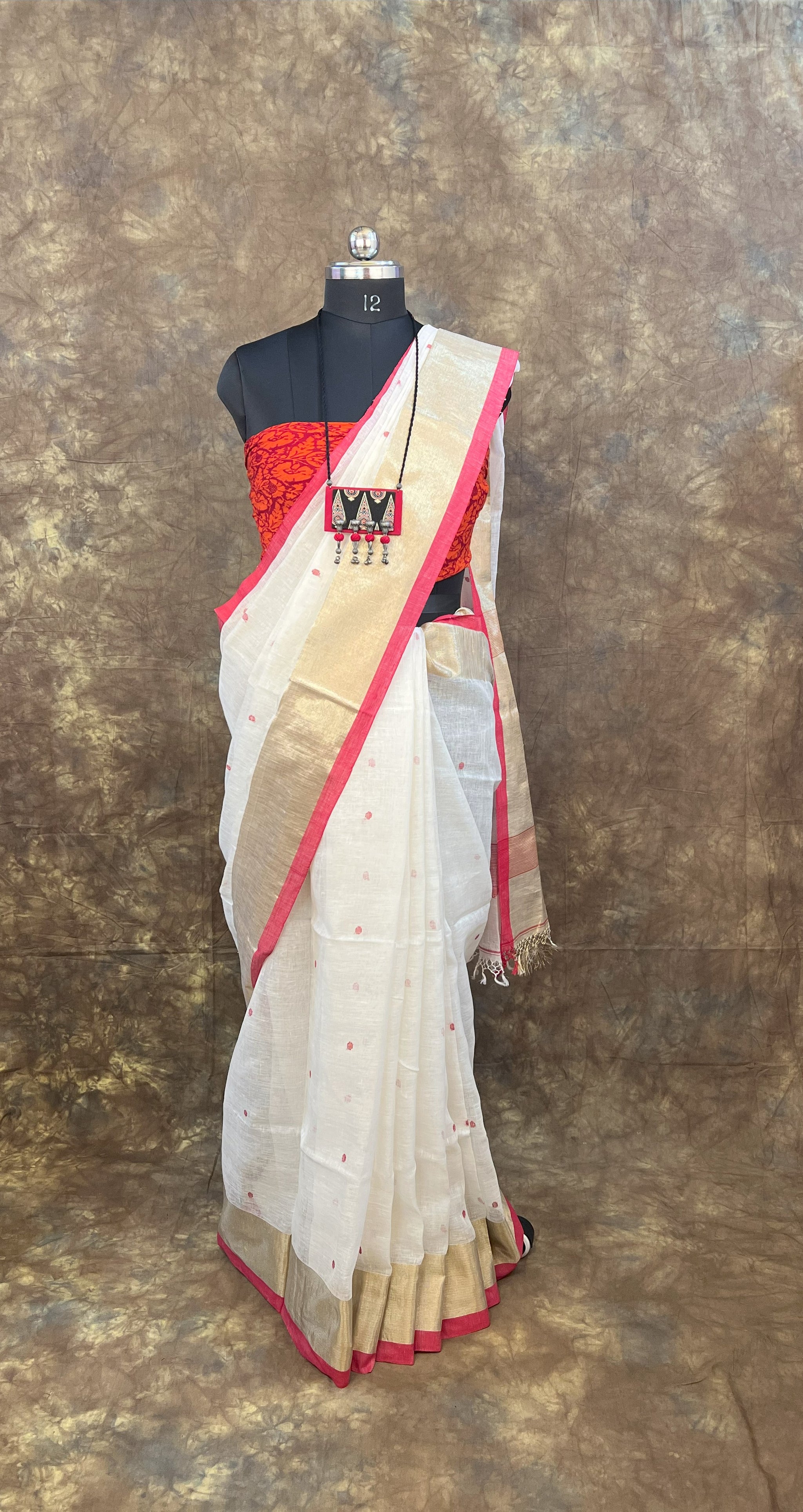 Side profile of model wearing Red White Linen Saree – Bengali Handloom Saree for festivals