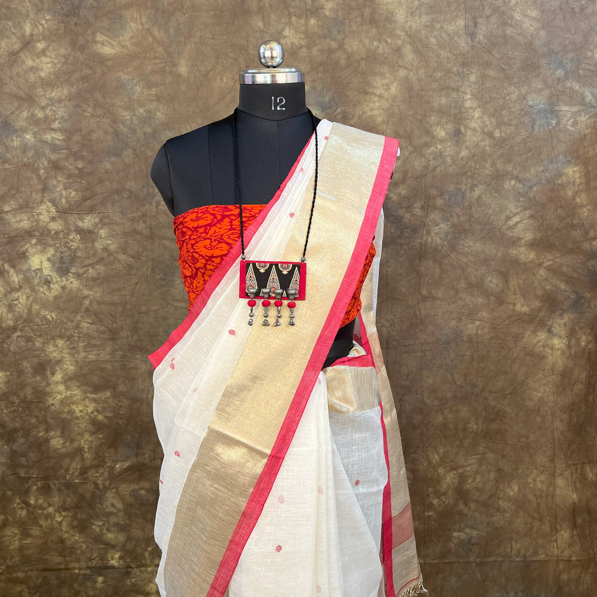 Close-up of Red White Linen Saree handloom border – Vaarnali festive collection