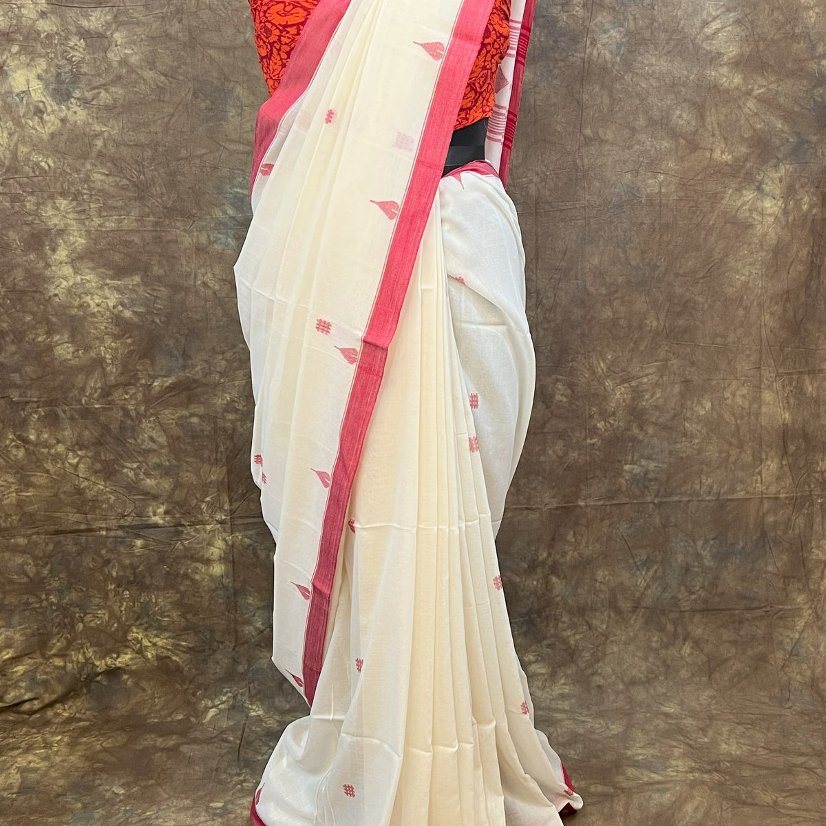 Durga Puja red and white saree draping style for women.