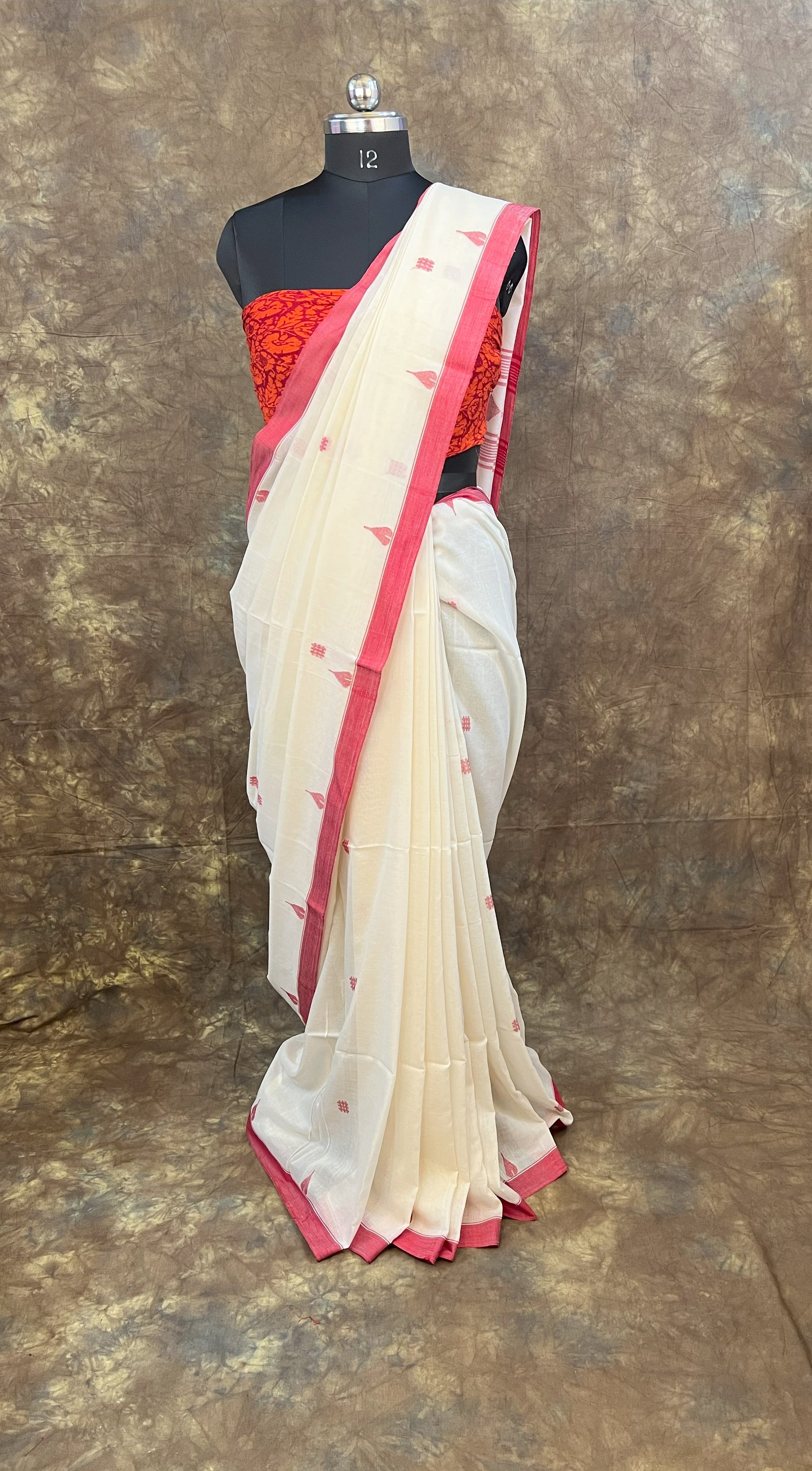 Durga Puja red and white saree draping style for women.