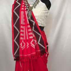Elegant saree in red and white handloom cotton with geometric borders and soft cotton texture.