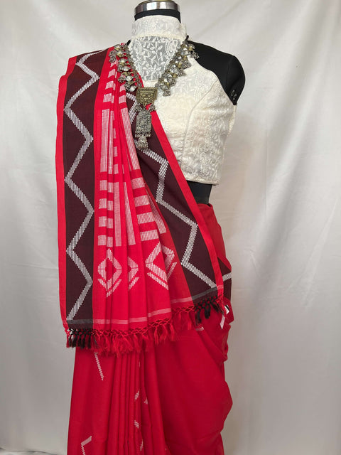Elegant saree in red and white handloom cotton with geometric borders and soft cotton texture.