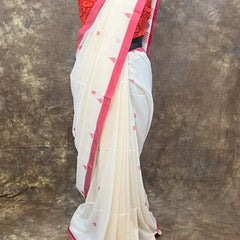 Elegant red and white saree styled for Sindoor Khela during Durga Puja.