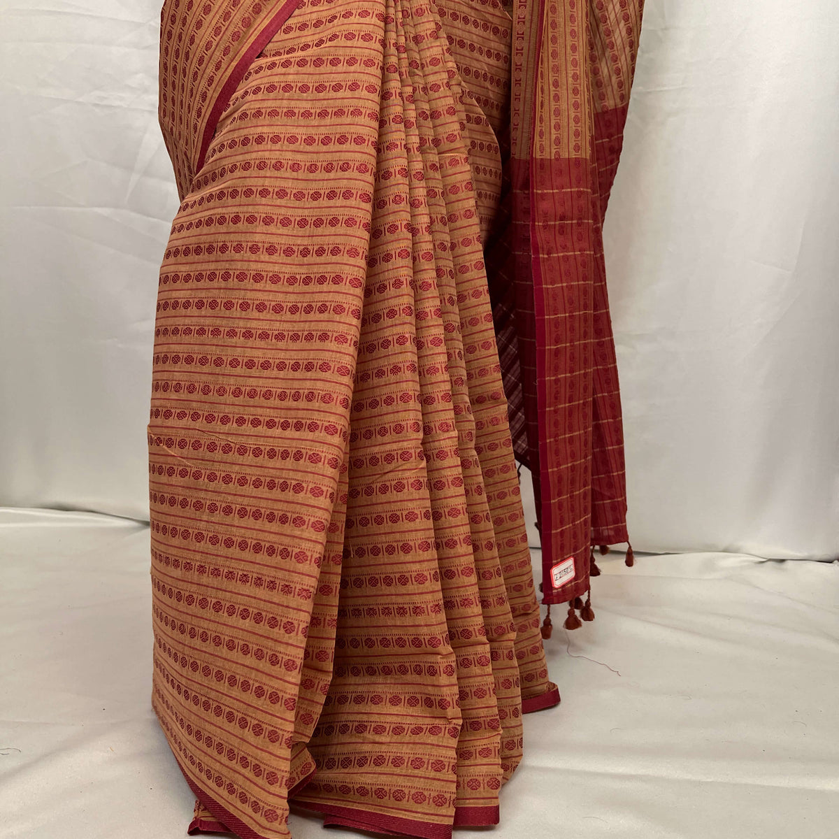 Close-up of woven red motifs on Tant cotton saree
