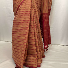 Close-up of woven red motifs on Tant cotton saree