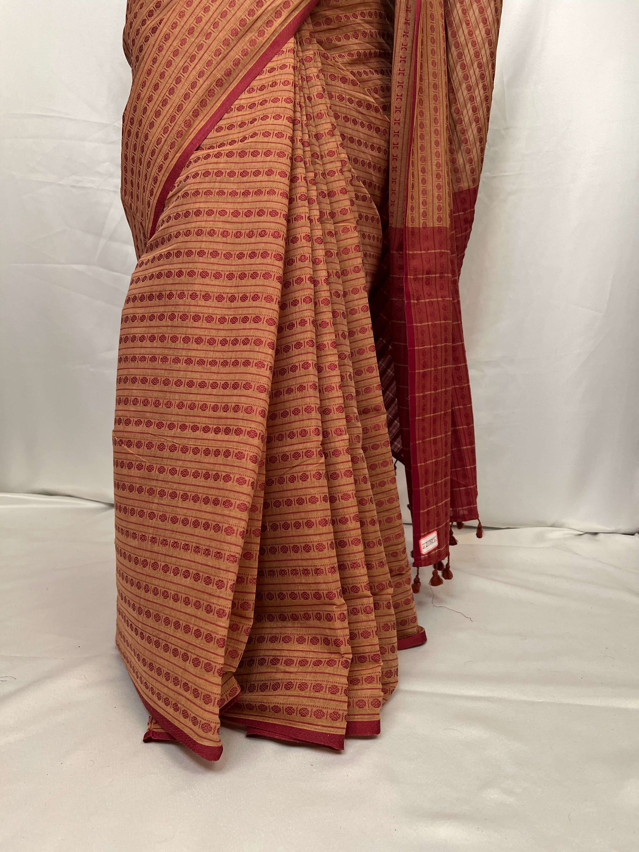 Close-up of woven red motifs on Tant cotton saree