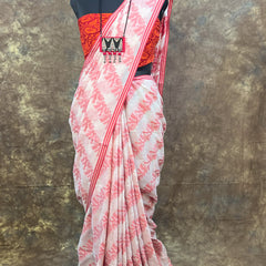 Traditional red and white cotton saree styled for festive Durga Puja celebrations.