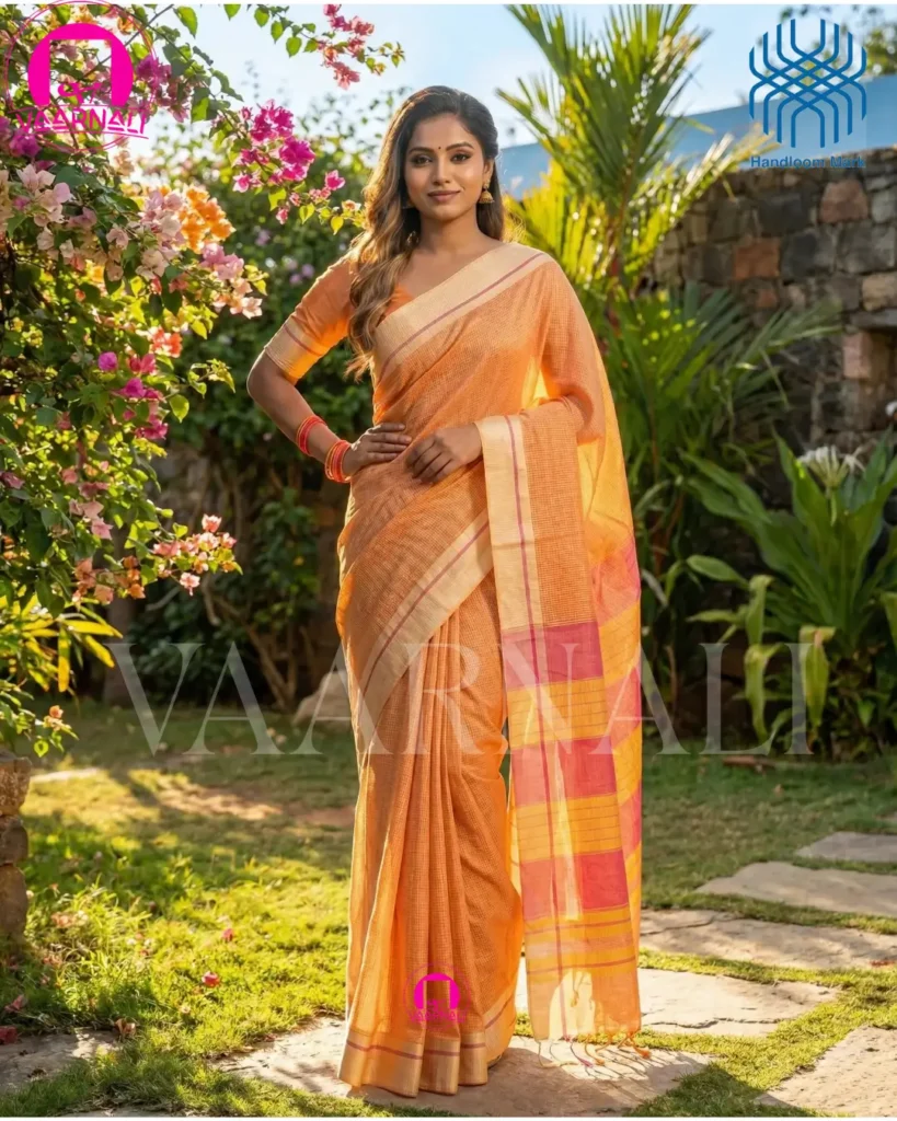 Model wearing yellow red patteda anchu saree outdoor garden setting pure handloom cotton VAARNALI