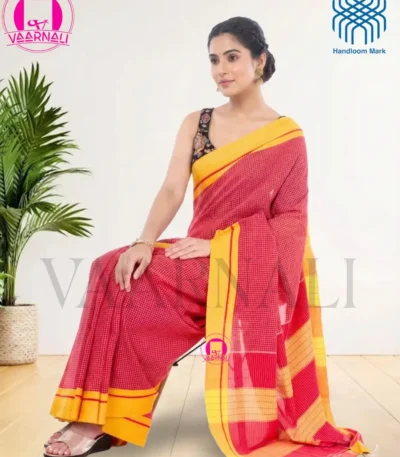 Woman posing in Patteda Anchu Red Cotton Saree with yellow border, traditional handloom design
