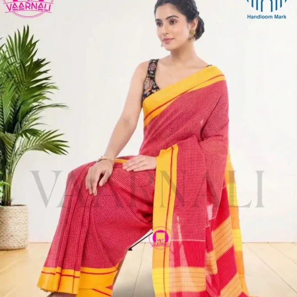 Woman posing in Patteda Anchu Red Cotton Saree with yellow border, traditional handloom design